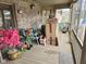 View of the porch, featuring brick walls, wood decking, and floral decor for outdoor relaxation at 4808 N Camelot Dr, Muncie, IN 47304