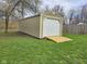 Backyard shed with white door and wooden ramp on a grassy lawn at 4808 N Camelot Dr, Muncie, IN 47304