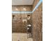 Detailed shot of a brown tiled shower with blue accents and a chrome shelving unit at 4808 N Camelot Dr, Muncie, IN 47304