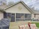 A sunroom with screened in porch and wooden deck with a sun decoration hanging on the exterior of the house at 4808 N Camelot Dr, Muncie, IN 47304