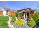 Landscaped backyard featuring a deck with wicker chairs and a ' Shed' under a pergola at 490 W Walnut St, Zionsville, IN 46077