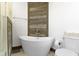 The bathroom is serene with a soaking tub and wood accent wall at 490 W Walnut St, Zionsville, IN 46077