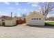Exterior view of a charming yellow house with a detached garage and additional storage shed at 490 W Walnut St, Zionsville, IN 46077