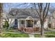 Charming home featuring a quaint front porch, brick stairs, and beautifully landscaped front yard at 490 W Walnut St, Zionsville, IN 46077