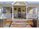 Inviting porch featuring neutral decor, stylish lighting, and brick steps leading to the entrance at 490 W Walnut St, Zionsville, IN 46077