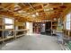 Spacious garage interior with wooden shelves, a refrigerator, and a workbench for storage and hobbies at 490 W Walnut St, Zionsville, IN 46077