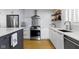 Modern kitchen with white cabinets, stainless steel appliances, and stylish backsplash at 490 W Walnut St, Zionsville, IN 46077