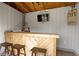 Cozy shed interior with a bar, stools, a TV, and rustic decor for a relaxing hangout at 490 W Walnut St, Zionsville, IN 46077