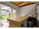 shed interior with a built-in bar, stools, an open doorway leading to a pergola-covered deck at 490 W Walnut St, Zionsville, IN 46077