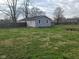 Large backyard enclosed by a wooden fence with a deck at 509 N Home Ave, Mooresville, IN 46158