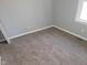 Bedroom featuring neutral gray walls, a window for natural light, and cozy carpeting at 509 N Home Ave, Mooresville, IN 46158