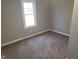 Bedroom featuring neutral gray walls, a window for natural light, and cozy carpeting at 509 N Home Ave, Mooresville, IN 46158