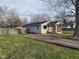 Charming single-story home with a covered porch and a spacious yard enclosed by a wooden fence at 509 N Home Ave, Mooresville, IN 46158