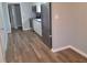 Eat in kitchen featuring stainless steel appliances, white cabinetry, and luxury laminate flooring at 509 N Home Ave, Mooresville, IN 46158