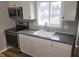 The kitchen has stainless steel appliances, white cabinets, and stone countertops at 509 N Home Ave, Mooresville, IN 46158