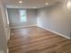 Open-concept living area featuring new paint, recessed lights, and laminate flooring throughout at 509 N Home Ave, Mooresville, IN 46158