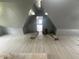 Unfinished attic showing potential as a bonus room with a new light gray floor at 554 N Tacoma Ave, Indianapolis, IN 46201