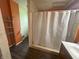 Functional bathroom showcasing a shower with a curtain, tiled floors and an orange wall accent at 554 N Tacoma Ave, Indianapolis, IN 46201