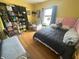 Cozy bedroom with wood floors, yellow walls, and eclectic decor at 554 N Tacoma Ave, Indianapolis, IN 46201