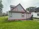 Exterior of the home with gray siding and red trim, featuring a small back porch at 554 N Tacoma Ave, Indianapolis, IN 46201