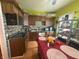 Kitchen featuring dark wood cabinets, mosaic backsplash, a marble countertop, and a table with a red table cloth at 554 N Tacoma Ave, Indianapolis, IN 46201