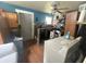 Laundry room with a washing machine, dryer, and overhead cabinets, with blue wall accents, plus vinyl wood flooring at 554 N Tacoma Ave, Indianapolis, IN 46201