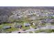Sprawling aerial view of a suburban neighborhood featuring numerous homes, trees, and winding roads at 6124 Dry Den Ct, Indianapolis, IN 46221