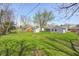 Wide shot of the grassy backyard with trees and sheds at 6124 Dry Den Ct, Indianapolis, IN 46221