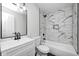 This bathroom has a modern vanity and tub with tiled walls at 6124 Dry Den Ct, Indianapolis, IN 46221