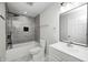 Modern bathroom featuring a shower with gray tiling, new toilet, and stylish mirror at 6124 Dry Den Ct, Indianapolis, IN 46221