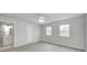 Bright bedroom featuring two windows, modern ceiling fan, and a doorway leading to the bathroom at 6124 Dry Den Ct, Indianapolis, IN 46221