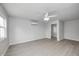 Neutral bedroom with hardwood flooring, large windows, and modern ceiling fan at 6124 Dry Den Ct, Indianapolis, IN 46221