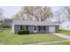 Charming single-story home with an attached garage, well-maintained lawn, and mature trees at 6124 Dry Den Ct, Indianapolis, IN 46221