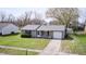 Inviting single-story home with an attached garage, tidy lawn, and blossoming tree in the front yard at 6124 Dry Den Ct, Indianapolis, IN 46221