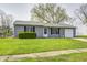 Charming single-story home with gray siding, front yard, and an attached one car garage at 6124 Dry Den Ct, Indianapolis, IN 46221