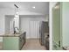 Charming kitchen featuring green cabinets, stainless steel appliances, and a unique countertop island at 6124 Dry Den Ct, Indianapolis, IN 46221