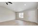 Spacious living room with updated floors, a ceiling fan, and ample natural light at 6124 Dry Den Ct, Indianapolis, IN 46221