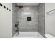 Shower featuring gray tile surround, black shower head, and built-in niche for added storage at 6124 Dry Den Ct, Indianapolis, IN 46221
