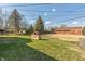 Expansive backyard features a brick outdoor cooker and mature trees for privacy at 6340 Bluebell Ct, Indianapolis, IN 46224