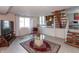 Relaxing lower-level living space with an open layout, tiled floors, natural light, and a modern staircase at 6340 Bluebell Ct, Indianapolis, IN 46224