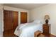 Bedroom with hardwood floors, wood doors, and window with natural light at 6340 Bluebell Ct, Indianapolis, IN 46224