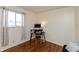 Bedroom with hardwood floors, a workstation, and window with natural light at 6340 Bluebell Ct, Indianapolis, IN 46224