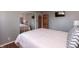 Comfortable bedroom featuring a mirrored closet, hardwood floors, and a mounted TV at 6340 Bluebell Ct, Indianapolis, IN 46224