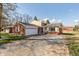 Charming single-story home featuring a brick facade, attached garage, and well-maintained front yard with mature trees at 6340 Bluebell Ct, Indianapolis, IN 46224