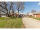 Wide angle of home exterior, showing tree cover, spacious lot, and a long driveway leading up to the attached garage at 6340 Bluebell Ct, Indianapolis, IN 46224