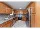 Spacious kitchen features wooden cabinets and stainless steel appliances at 6340 Bluebell Ct, Indianapolis, IN 46224