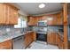 Bright kitchen with stainless steel appliances, granite countertops, and wooden cabinets at 6340 Bluebell Ct, Indianapolis, IN 46224