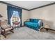 Bedroom with daybed, floral wallpaper accents, rocking chair, and a bright window at 641 Beech W Dr, Plainfield, IN 46168