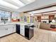 Well-lit kitchen with white cabinetry, tile floors, and an open view to the living area at 641 Beech W Dr, Plainfield, IN 46168