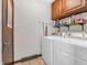 Laundry room with washer, dryer, upper cabinets, and tile floor at 641 Beech W Dr, Plainfield, IN 46168